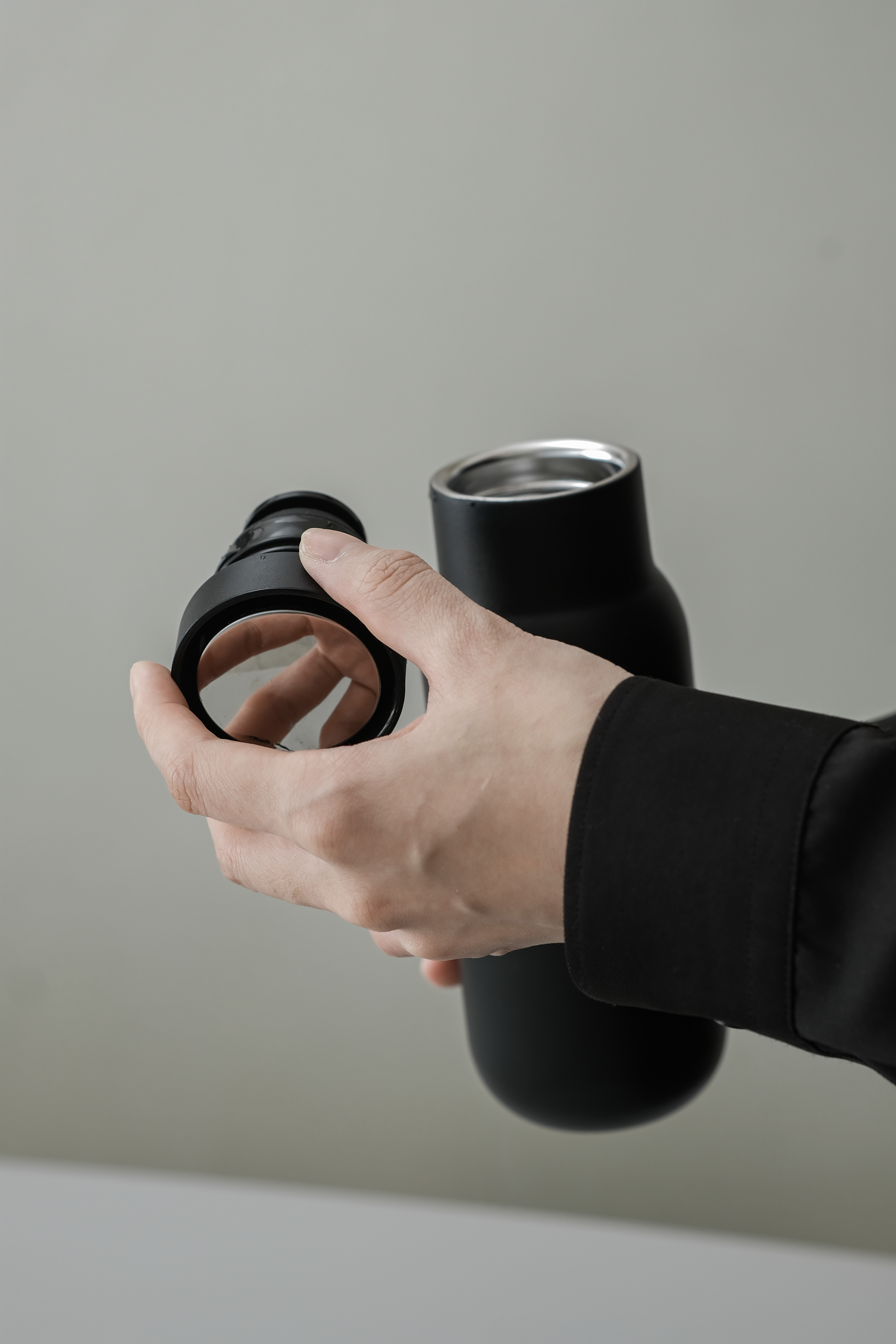 Matte green 350ml stainless steel vacuum bottle on a wooden desk, next to a laptop and a plant, showing compact daily use