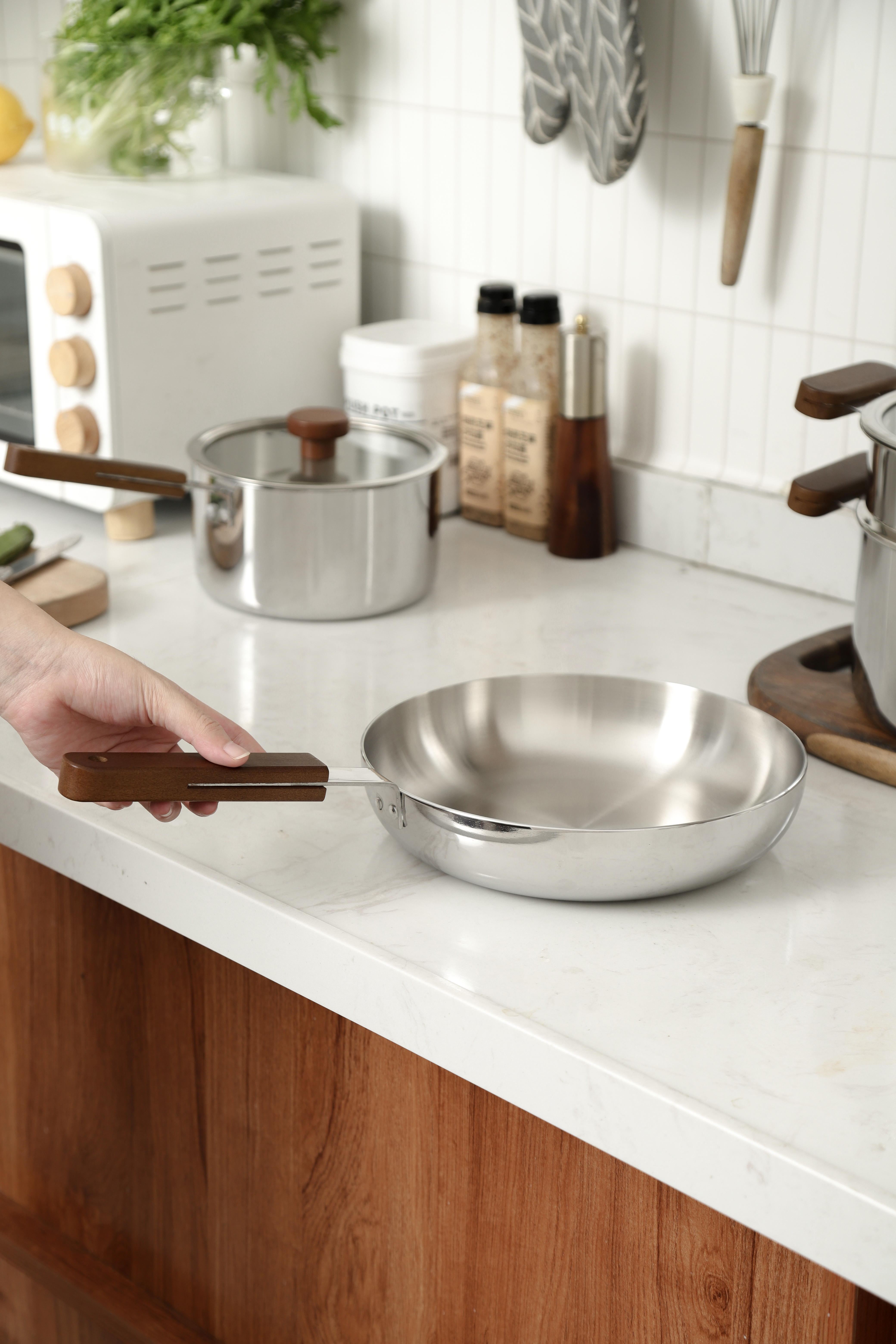 Stainless Steel Steamer Pot Set (3 - Layer) with Wooden Handles - Kitchen Countertop with Toaster, Spices, and Cooking Essentials, White Tiled Background