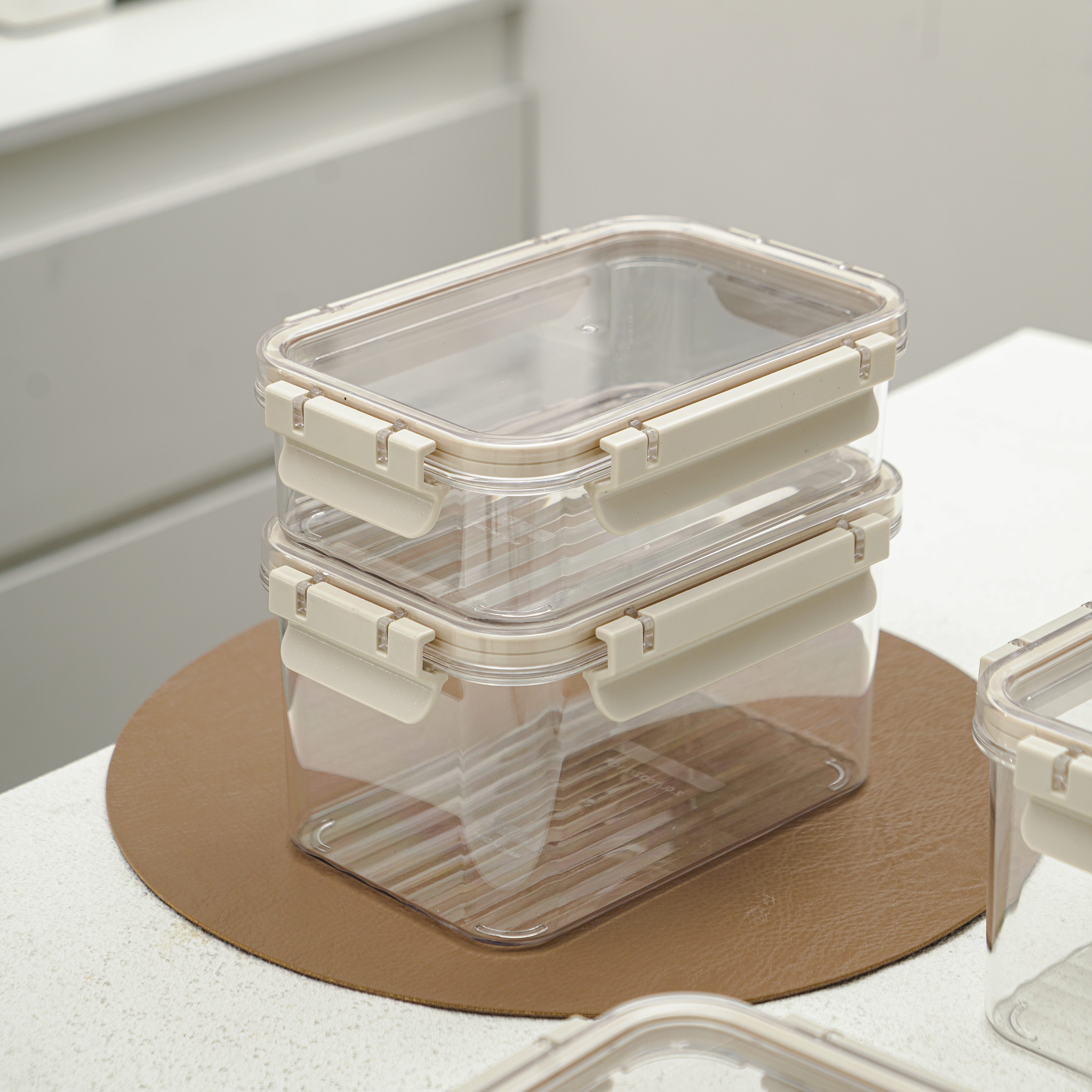 Set of leakproof plastic food storage containers with airtight lids, transparent body, and brown locking clips.