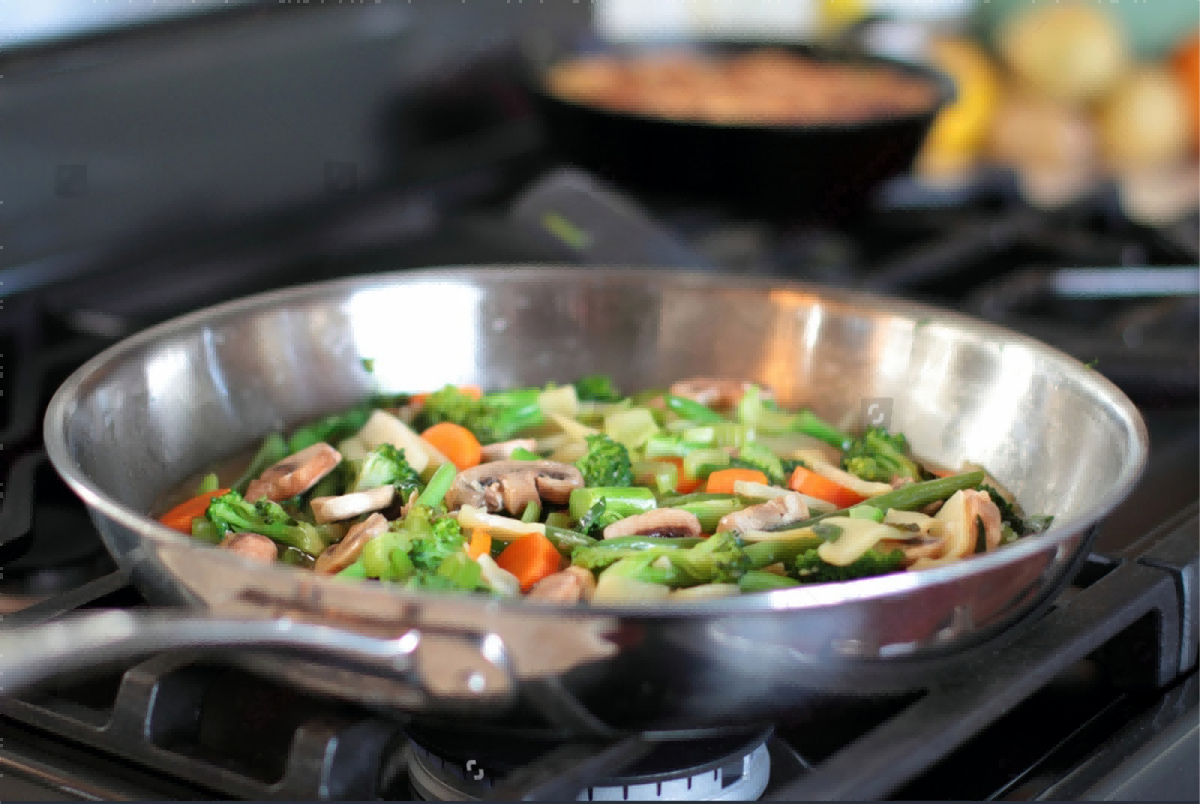 Sautéing vegetables in a stainless steel frying pan